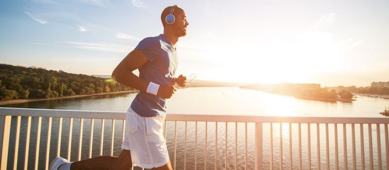 Young athlete jogging by river